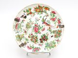 a plate with a bird and flowers design on it