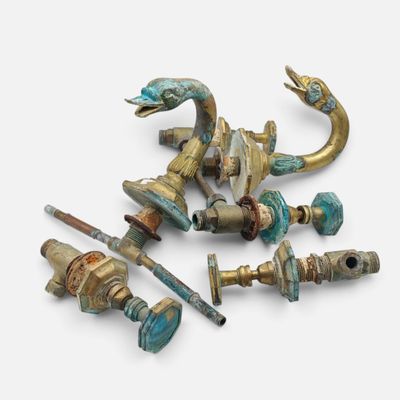 a group of brass and turquoise colored items on a white surface