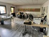 a room with a lot of desks and chairs in it
