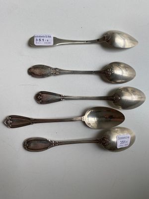 four spoons are lined up in a row on a table