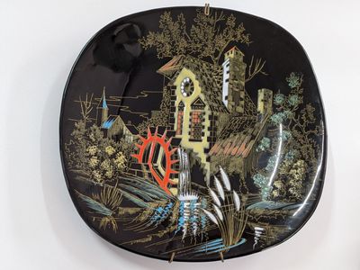 a black plate with a picture of a castle on it