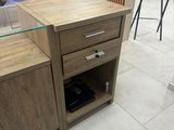 a small desk with a glass top in a room