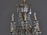 an antique brass and crystal chandelier with four lights