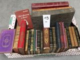 many old books in a box on the floor