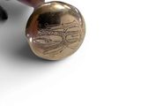 a person holding a gold coin with a picture of a train on it