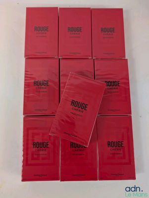 a pile of red books sitting on top of a white table
