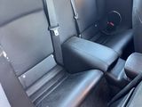 a picture of the inside of a car with black leather seats