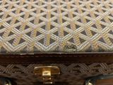 a close up of a purse with a gold handle