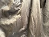 a close up of a jacket with a monogram on it