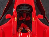 a close up of a red race car with a red seat belt