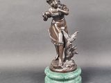 bronze figurine of a woman playing the flute