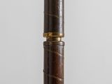 an image of a close up of a wooden pole with a black and gold stripe