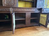 a wooden cabinet with a door open on a hard wood floor