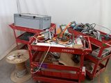 a red cart with wires and wires on it in a room