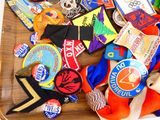 a wooden tray with many different types of badges on it
