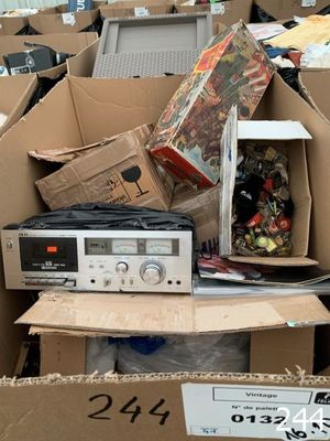 a pile of boxes with electronic equipment inside of it