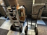 two hand trucks that are sitting next to each other on the floor