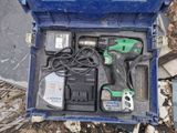 a blue tool box with tools in it sitting on the ground