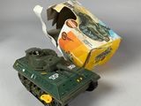 a toy tank that is sitting next to a box