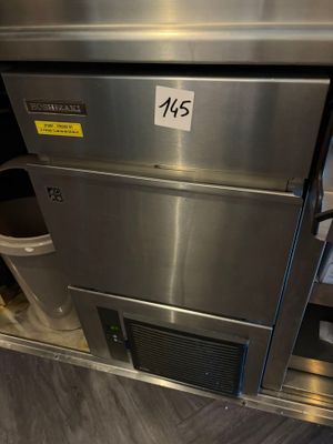a stainless steel oven that has a trash can underneath it