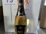a bottle of wine sitting on a table next to a box