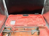 a tool in a red case on a black table