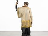an image of a statue of a man holding a cross in his hand