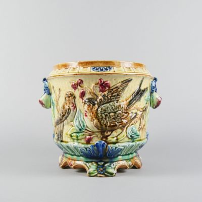 a vase with a bird and flowers on it