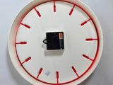 a white plate with a red line around it and a battery in the middle of the plate