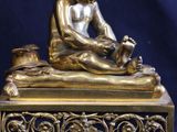 a statue of a boy sitting on top of a table