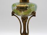 une lampe en verre posée sur un pied