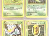 four pokemon cards of different colors and designs on a white surface