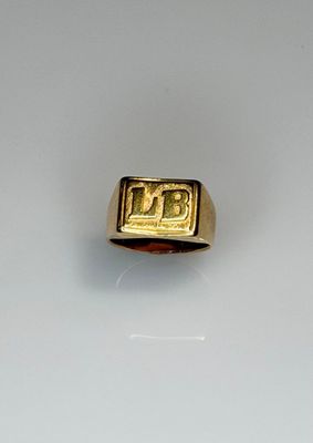 an image of a gold ring with the letter b on it
