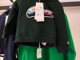 clothing hanging on a rack in a clothing store with tags on it