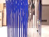 a blue sculpture made out of forks and spoons on the floor