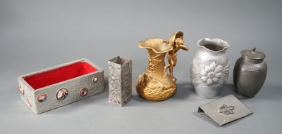 trois vases, une boîte et une boîte posée sur une table