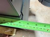a measuring tape that is being used to measure a piece of furniture