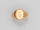 a gold signet ring with the initials of two men