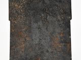 an old metal plate with a rusted surface on a white surface