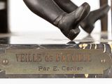 a bronze statue of a person sitting on a bench