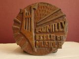 a wooden plaque with a clock on it on a table