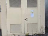 two doors that are open on the side of a building
