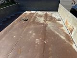 a dirty flat bed on the roof of a truck