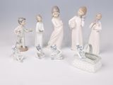 five figurines of people with a baby in a crib