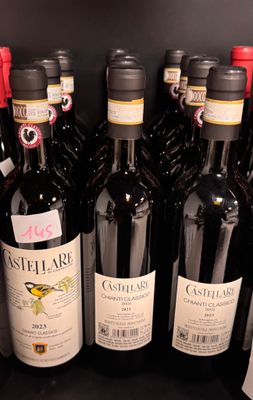 many bottles of wine on the shelf in the store