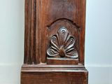 a wooden grandfather clock that is in the corner of a room
