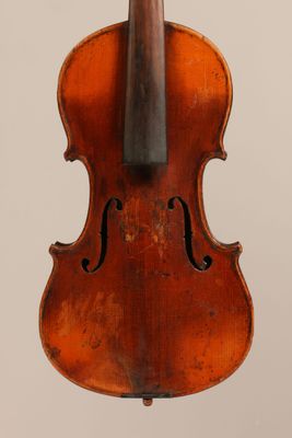 an old violin with a bow hanging from it ' s back