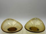 pair of yellow glass bowls on white surface with white background
