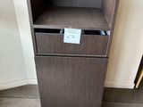 a wooden cabinet with a drawer on top of it