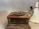 an old fashioned gramphone and a vase on a table